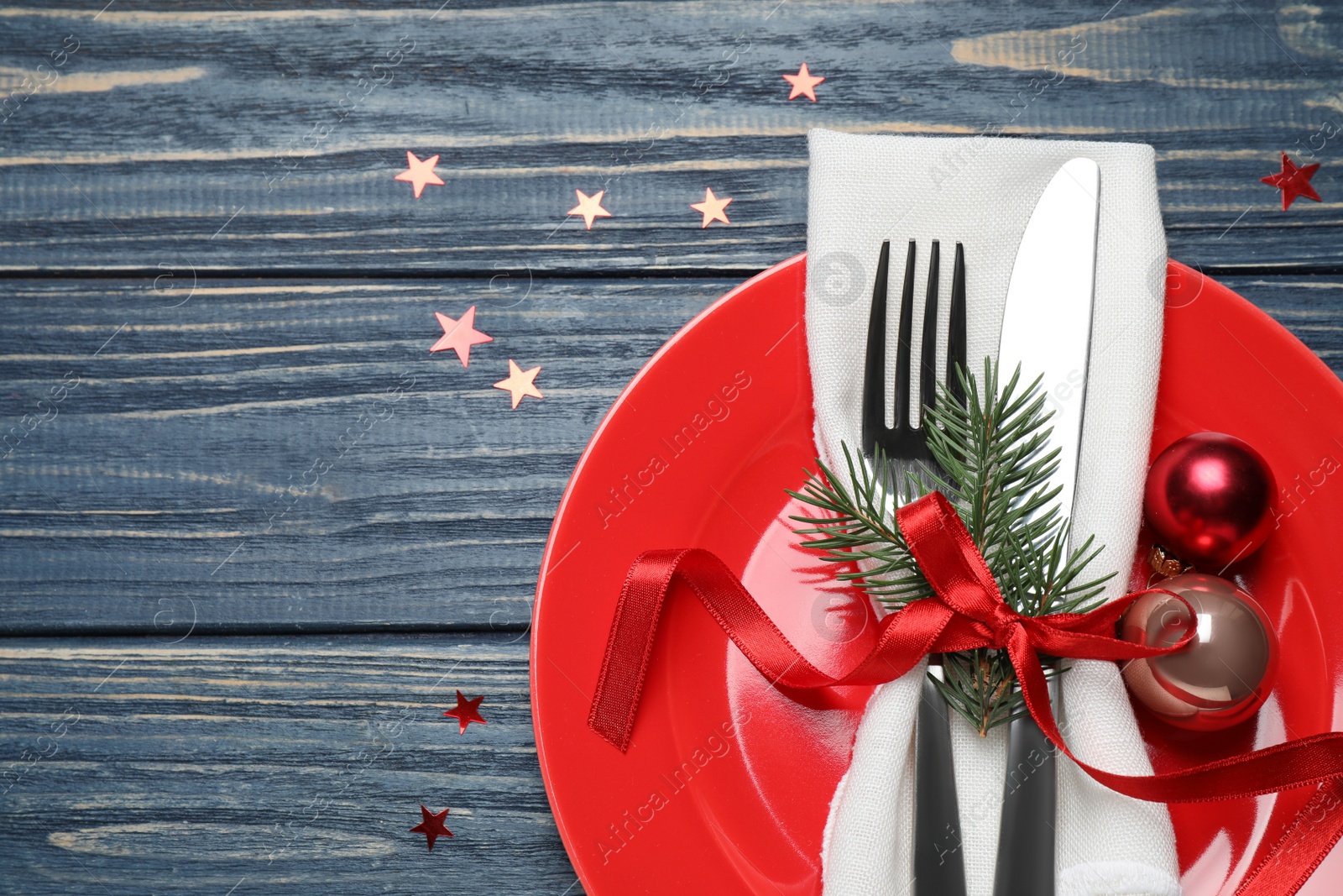 Photo of Christmas table setting on blue wooden background, top view. Space for text