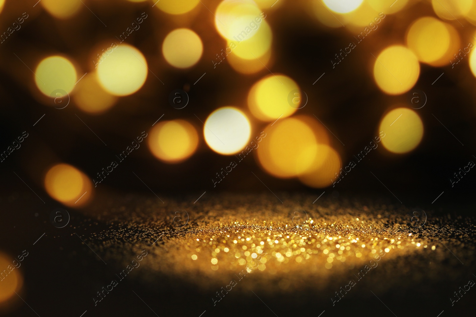 Photo of Gold glitter with bokeh effect on black background