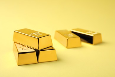 Shiny gold bars on yellow background. Space for text