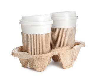 Photo of Takeaway paper coffee cups with sleeves in cardboard holder on white background