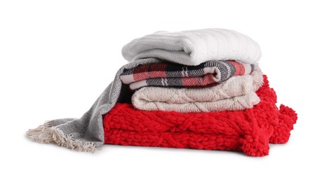 Stack of folded warm plaids on white background