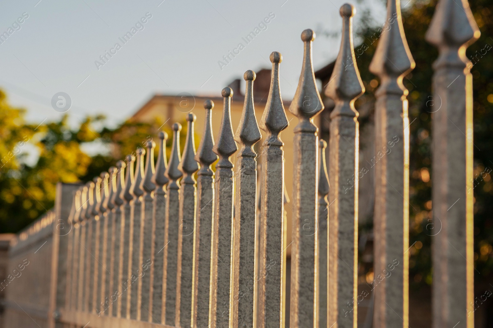 Photo of Beautiful iron fence on sunny day outdoors, closeup