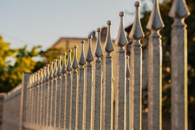 Beautiful iron fence on sunny day outdoors, closeup