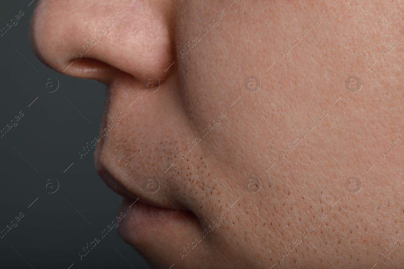 Photo of Closeup view of man with healthy skin on light grey background