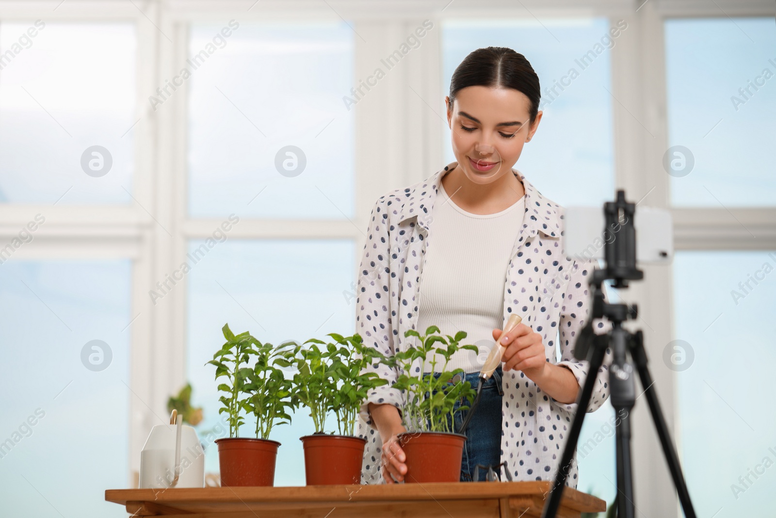 Photo of Teacher conducting online gardening course at home. Time for hobby