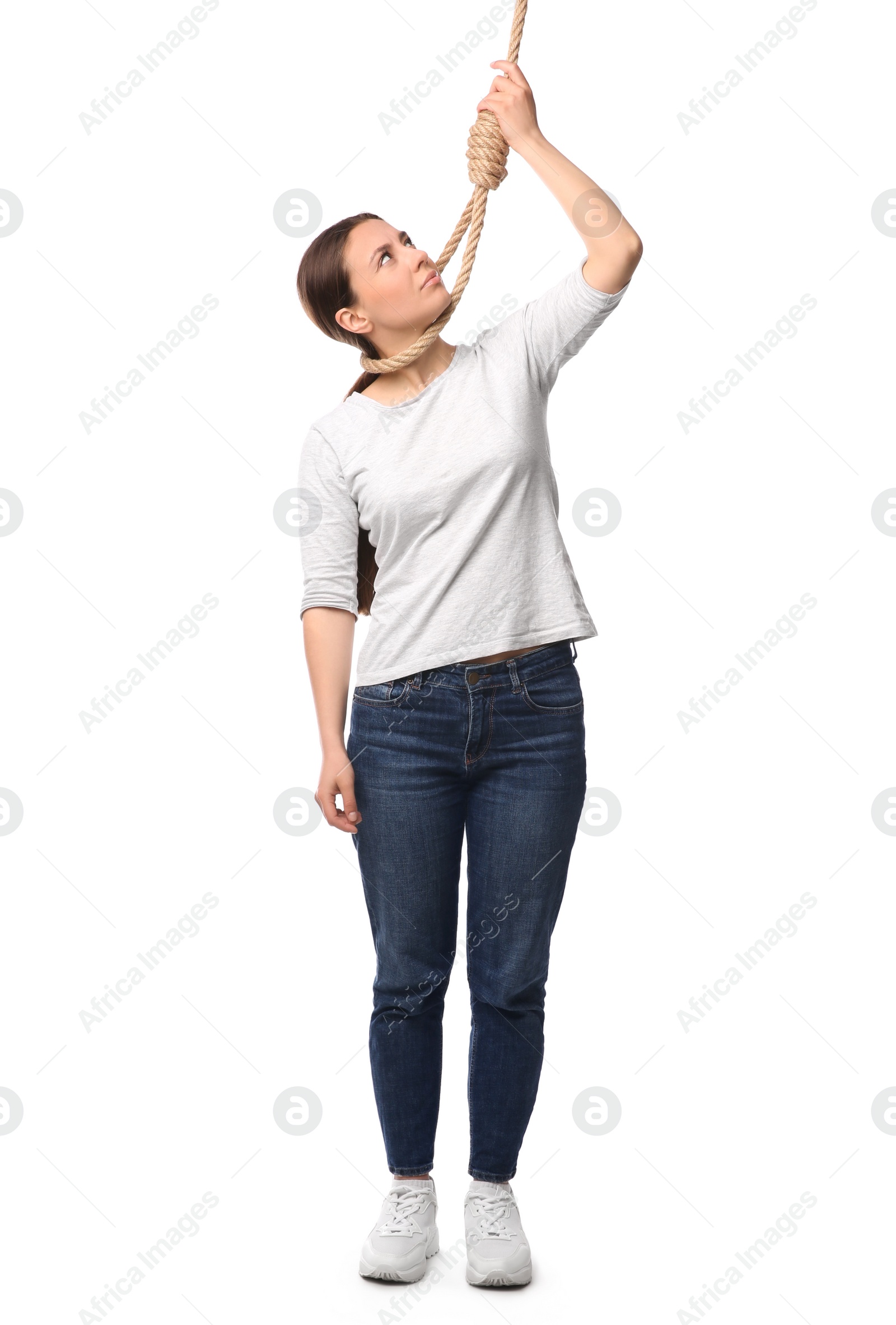 Photo of Depressed woman with rope noose on neck against white background