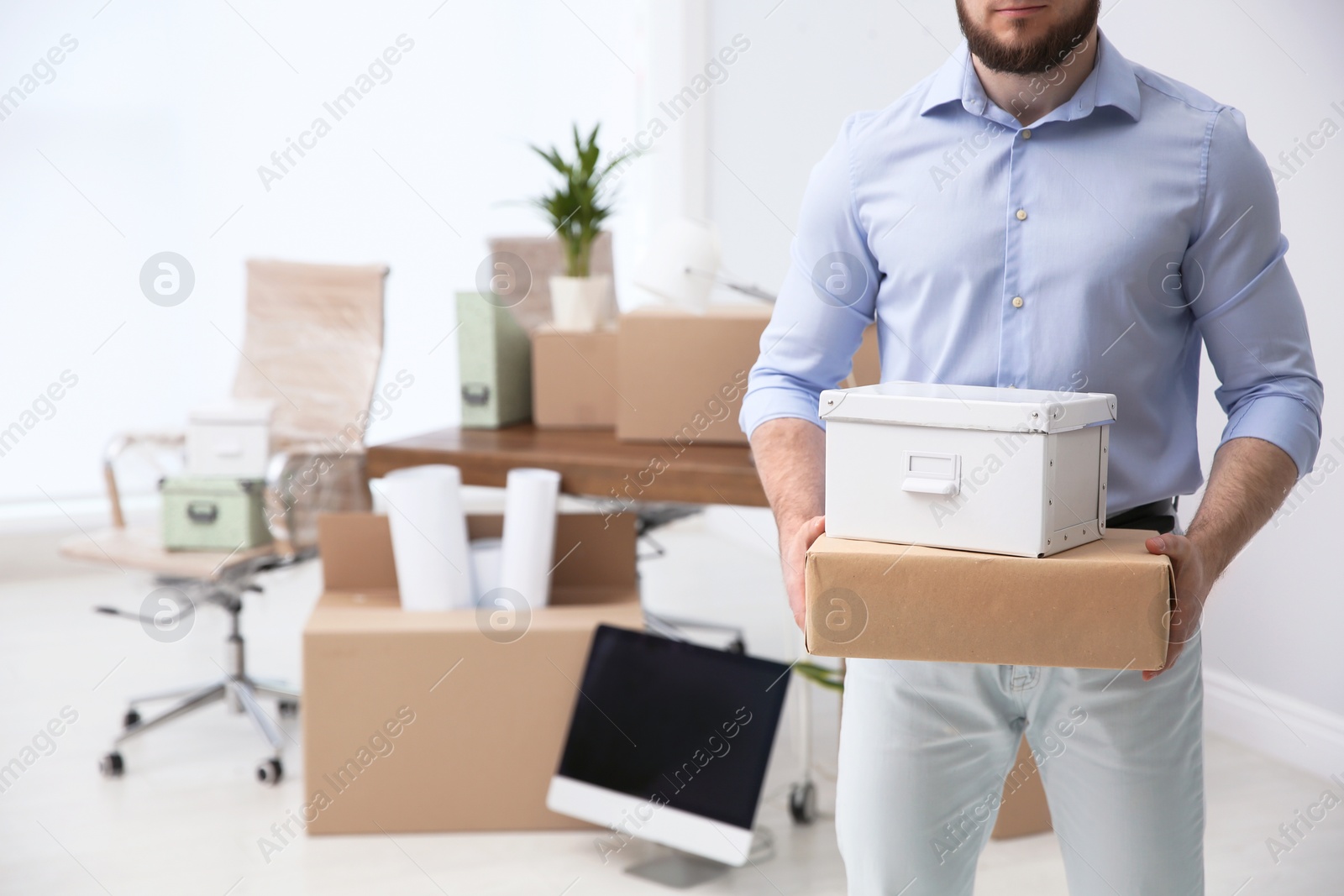 Photo of Man holding moving boxes in new office, closeup. Space for text