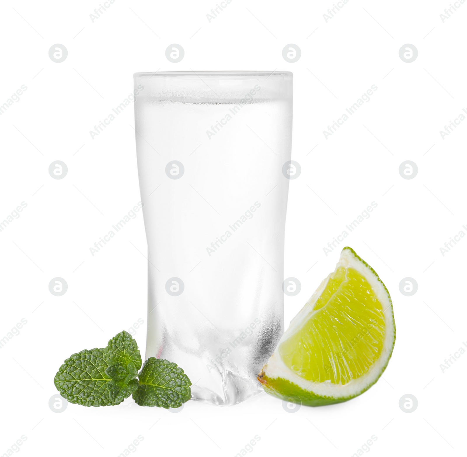 Photo of Glass of vodka, mint and lime isolated on white