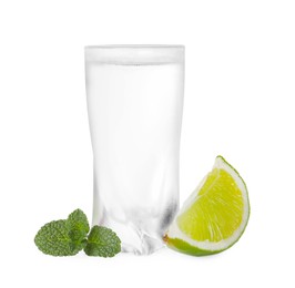 Photo of Glass of vodka, mint and lime isolated on white