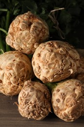 Fresh raw celery roots on wooden table, closeup