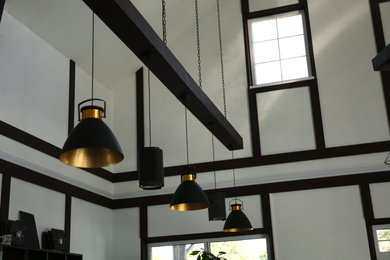 Photo of Stylish hanging lamps indoors. idea for interior design