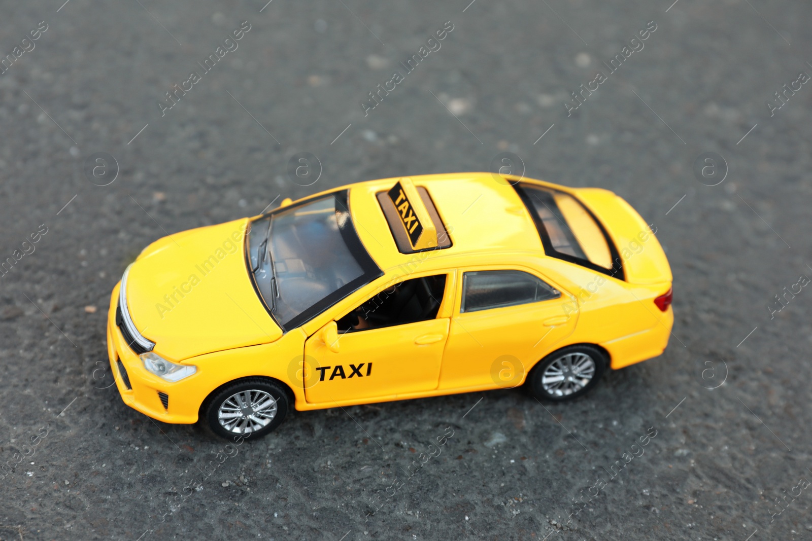 Photo of Yellow taxi car model on city street