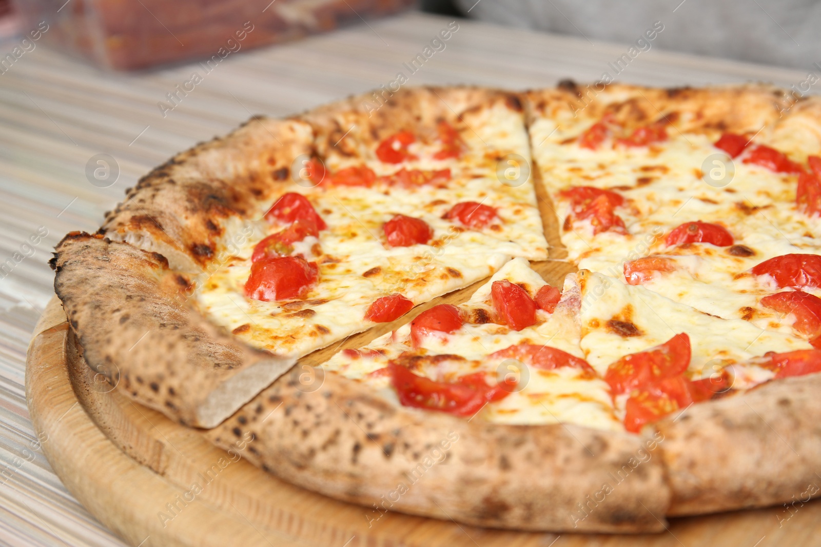 Photo of Tasty Italian oven baked pizza on wooden table in restaurant