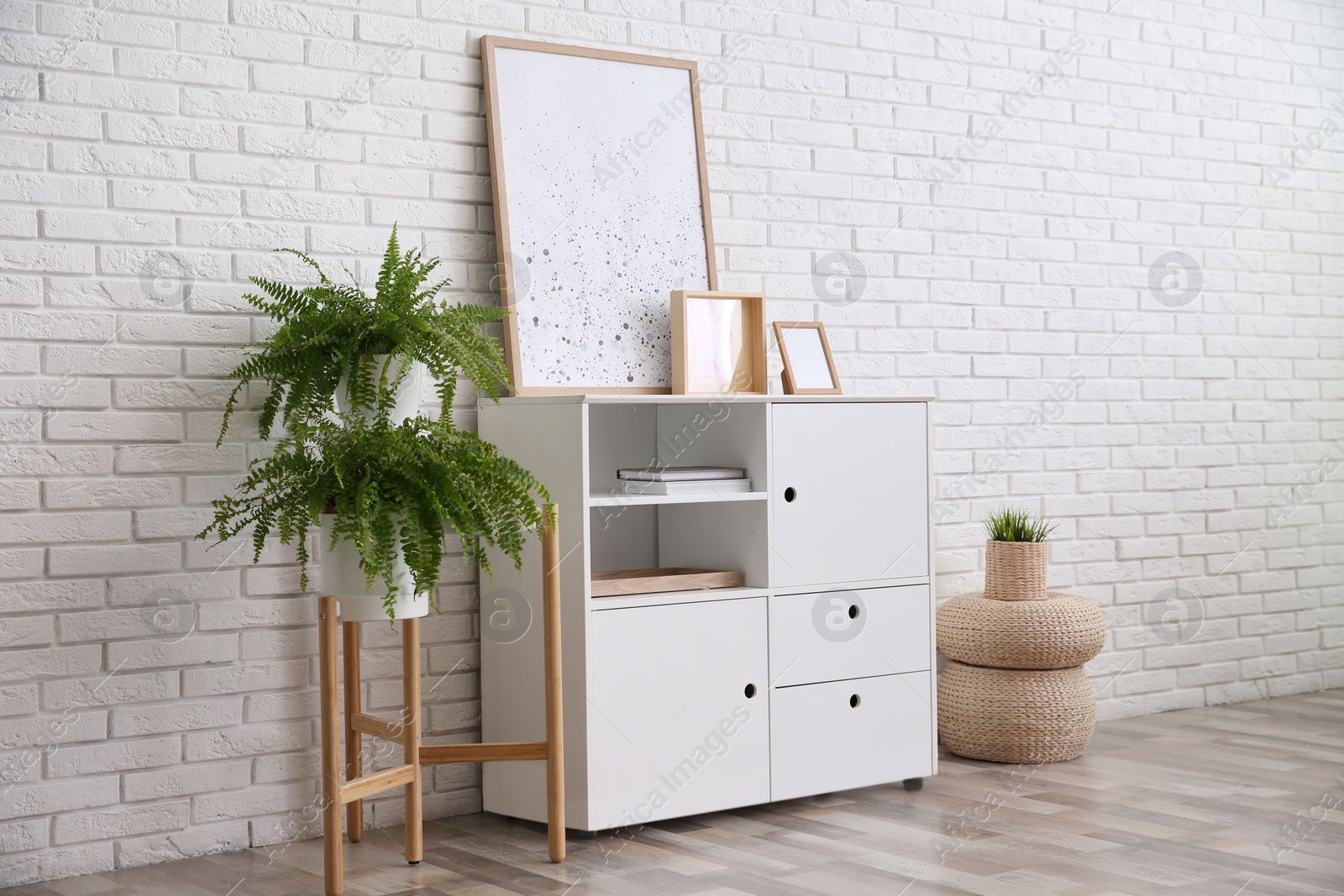 Photo of Modern room interior with stylish white cabinet