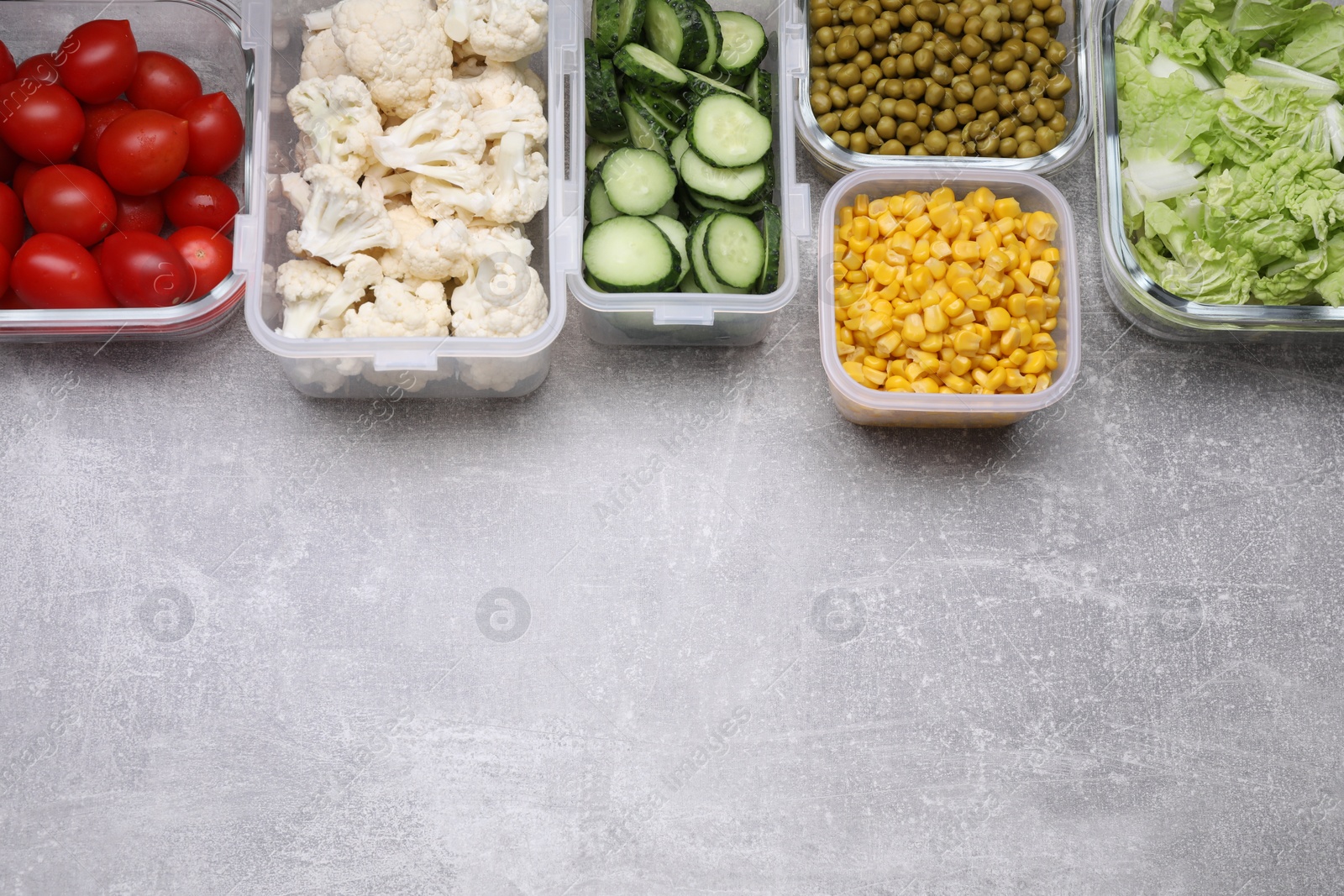 Photo of Glass and plastic containers with different fresh products on light grey table, flat lay. Space for text