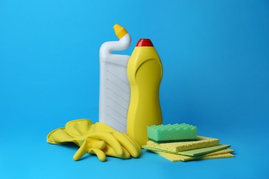 Photo of Cleaning supplies and tools on light blue background