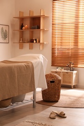 Photo of Stylish massage room interior in spa salon