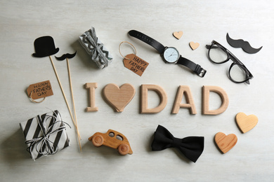 Photo of Flat lay composition with phrase I LOVE DAD on white background. Happy Father's day