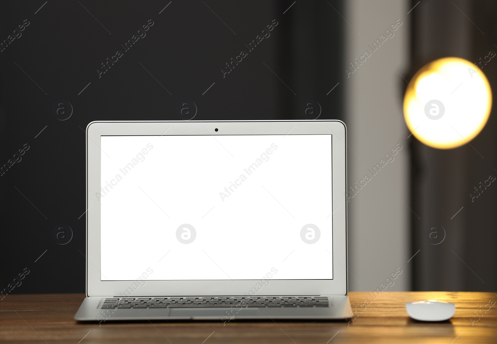 Photo of Laptop with blank screen on table indoors. Space for text