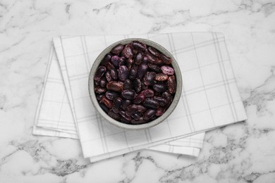 Photo of Bowl with dry kidney beans on white marble table, top view