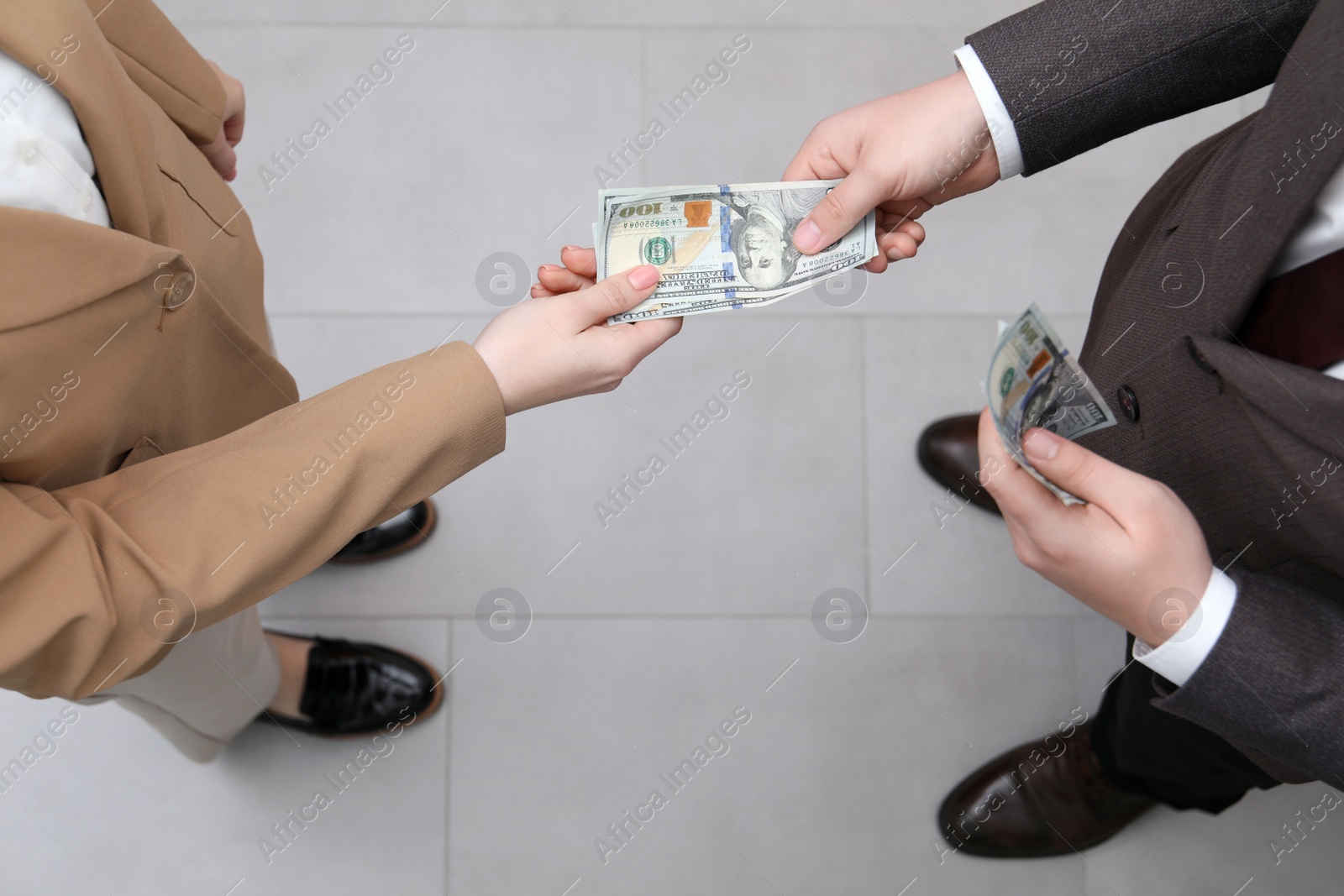 Photo of Man giving money to woman indoors, above view. Currency exchange