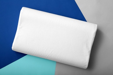 Photo of Soft bed pillow on color background, top view