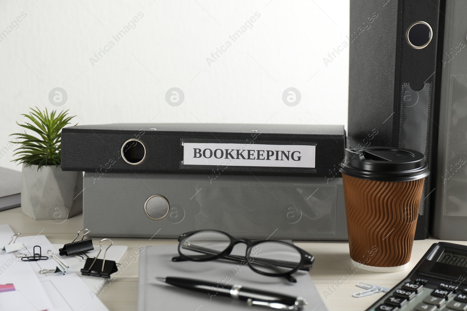 Photo of Bookkeeper's workplace with folders and documents on table