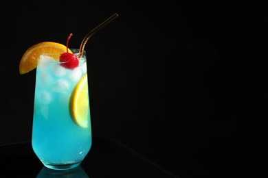 Photo of Glass of delicious cocktail on black background. Space for text