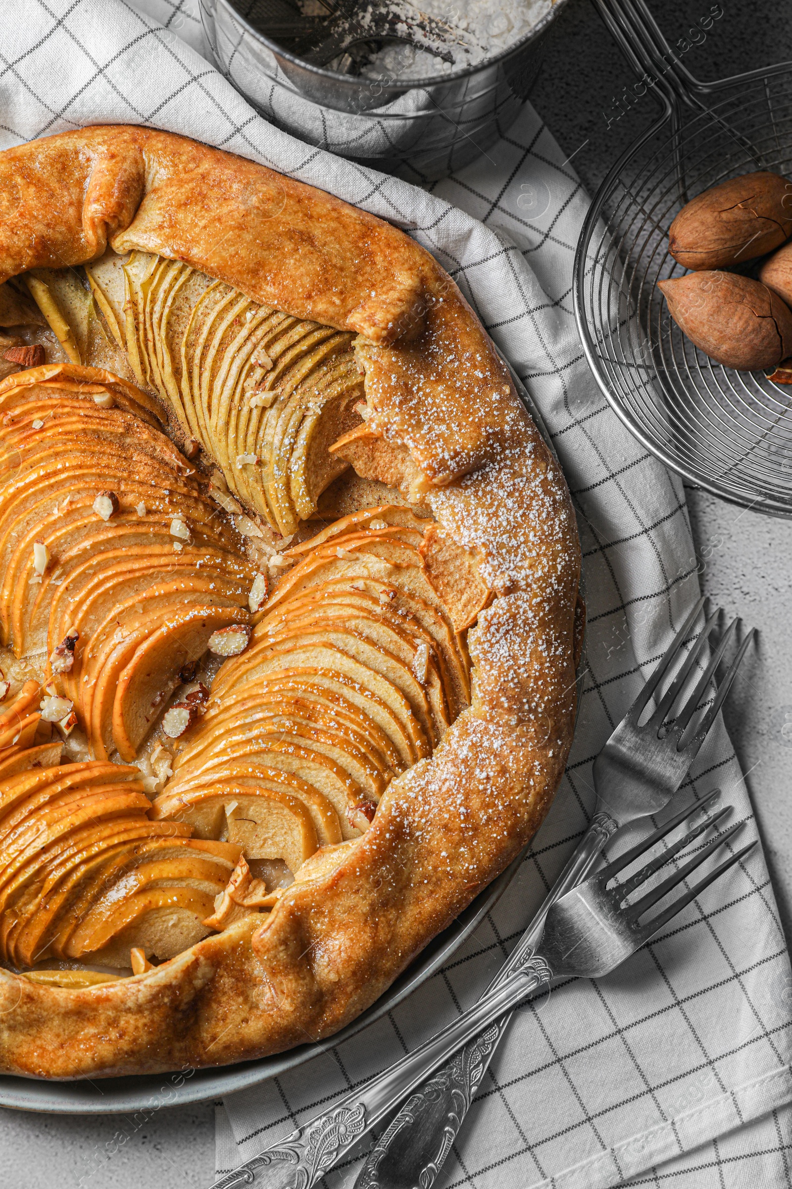 Photo of Delicious apple galette with pecans and forks on table, flat lay