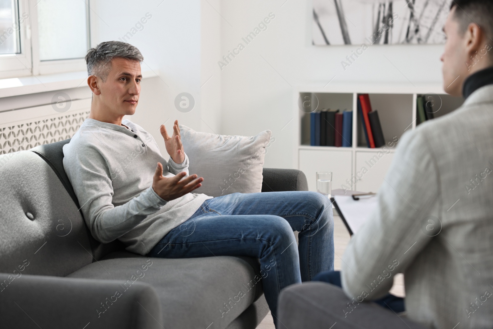 Photo of Professional psychotherapist working with patient in office