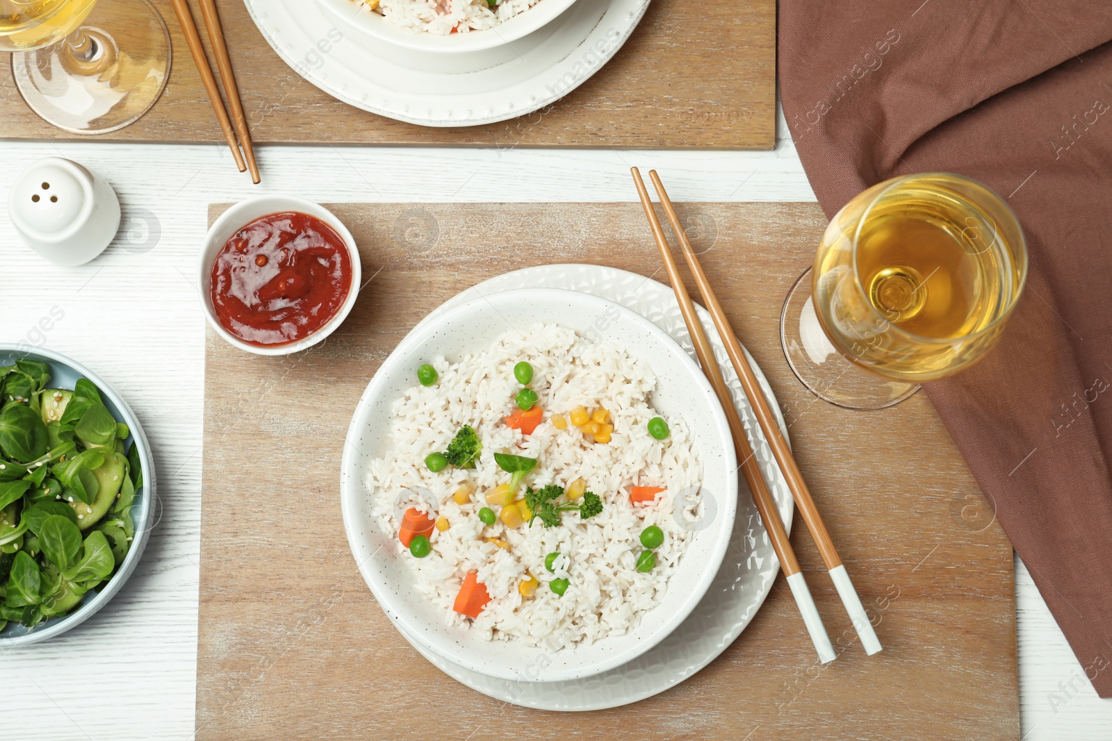 Photo of Boiled rice with vegetables served on table, flat lay