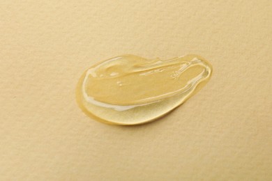 Photo of Swatch of cosmetic gel on beige background, closeup