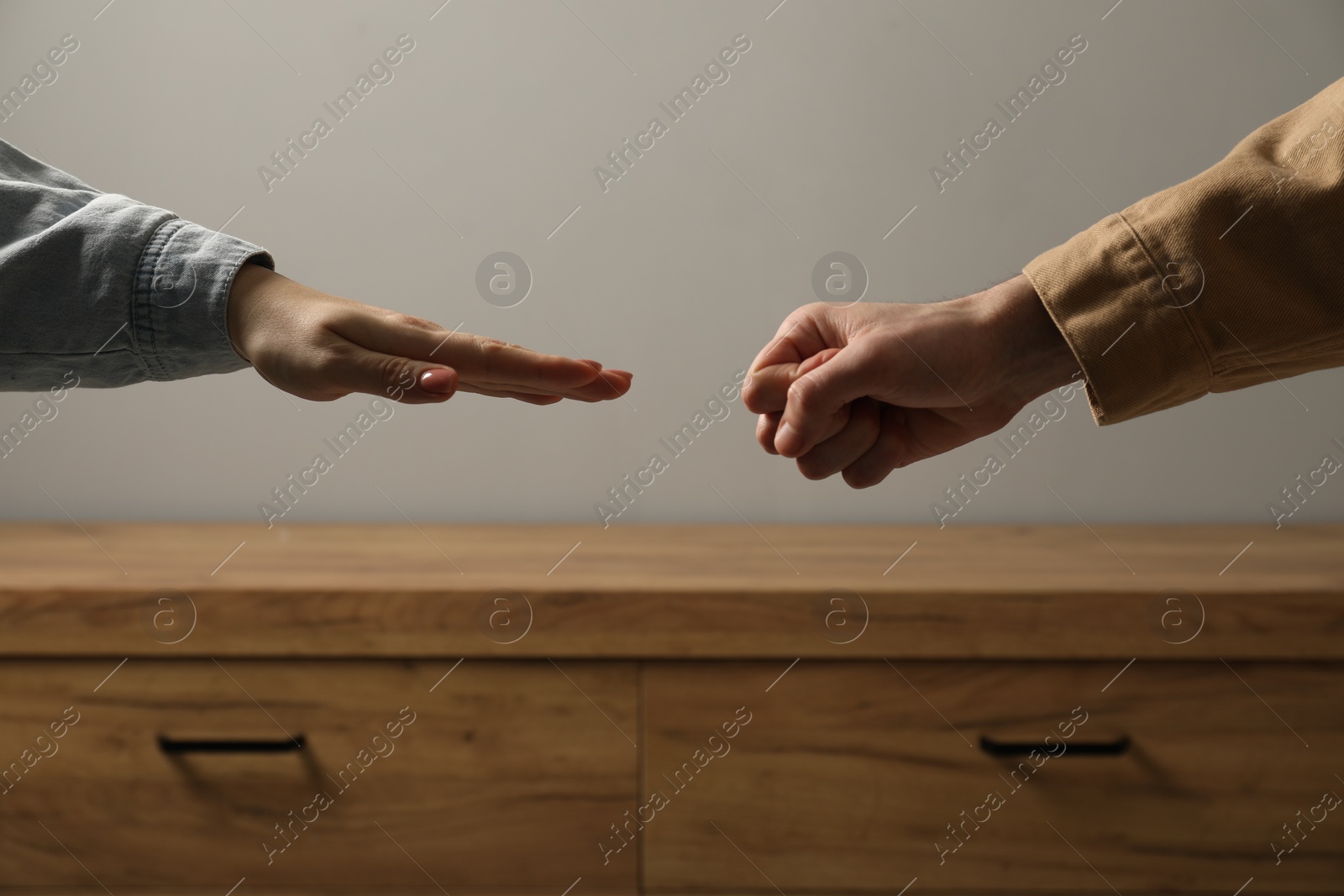 Photo of People playing rock, paper and scissors indoors, closeup