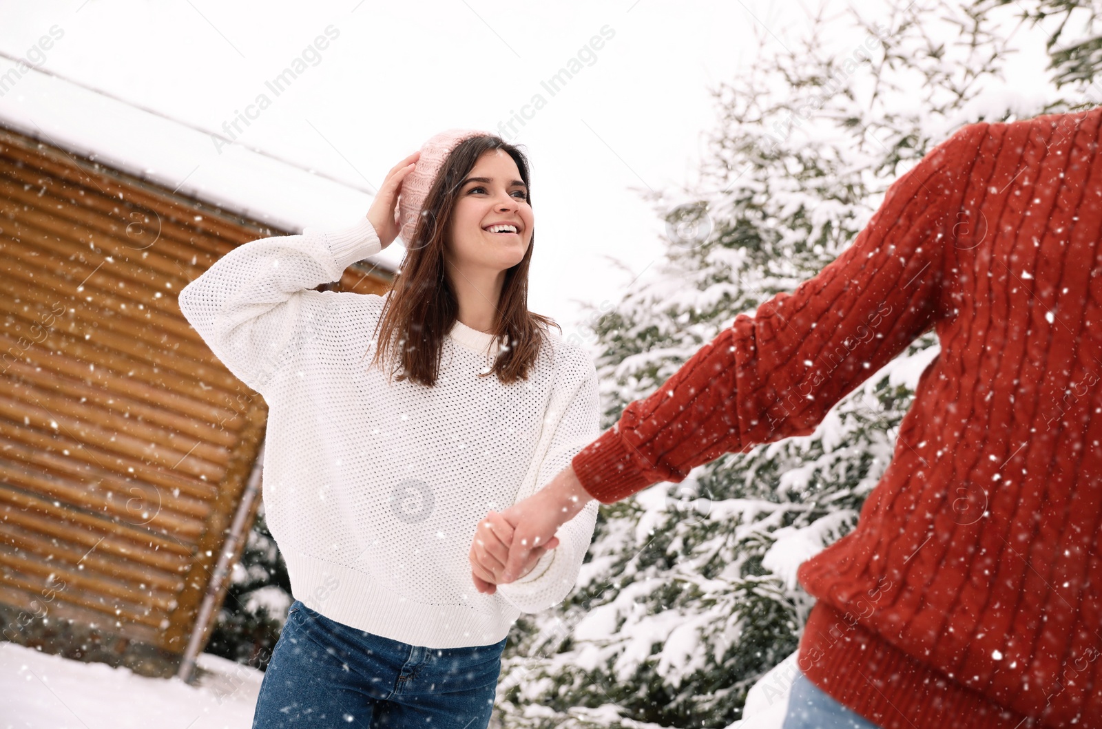 Photo of Lovely couple walking together on snowy day. Winter vacation