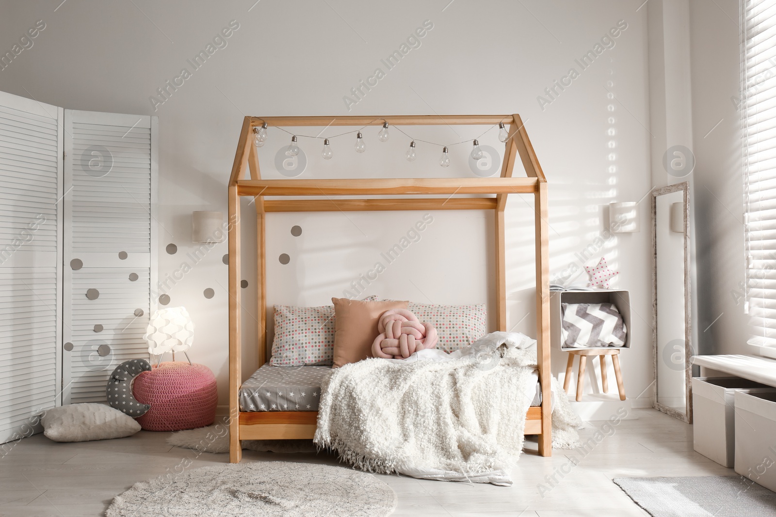 Photo of Cozy child room interior with comfortable bed