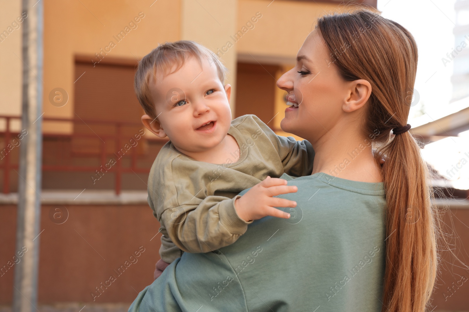 Photo of Happy nanny with cute little boy outdoors