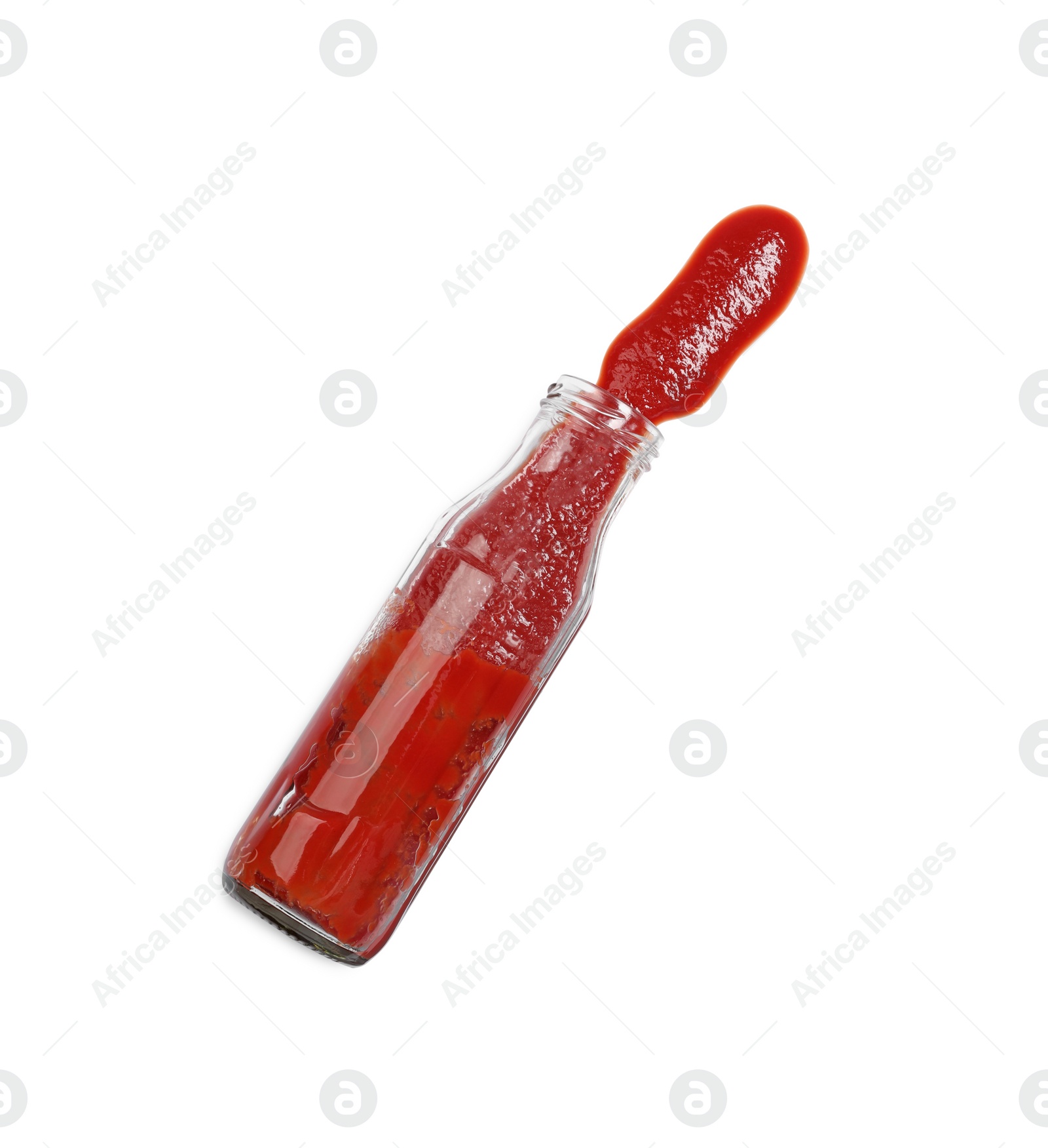 Photo of Ketchup and glass bottle isolated on white, top view