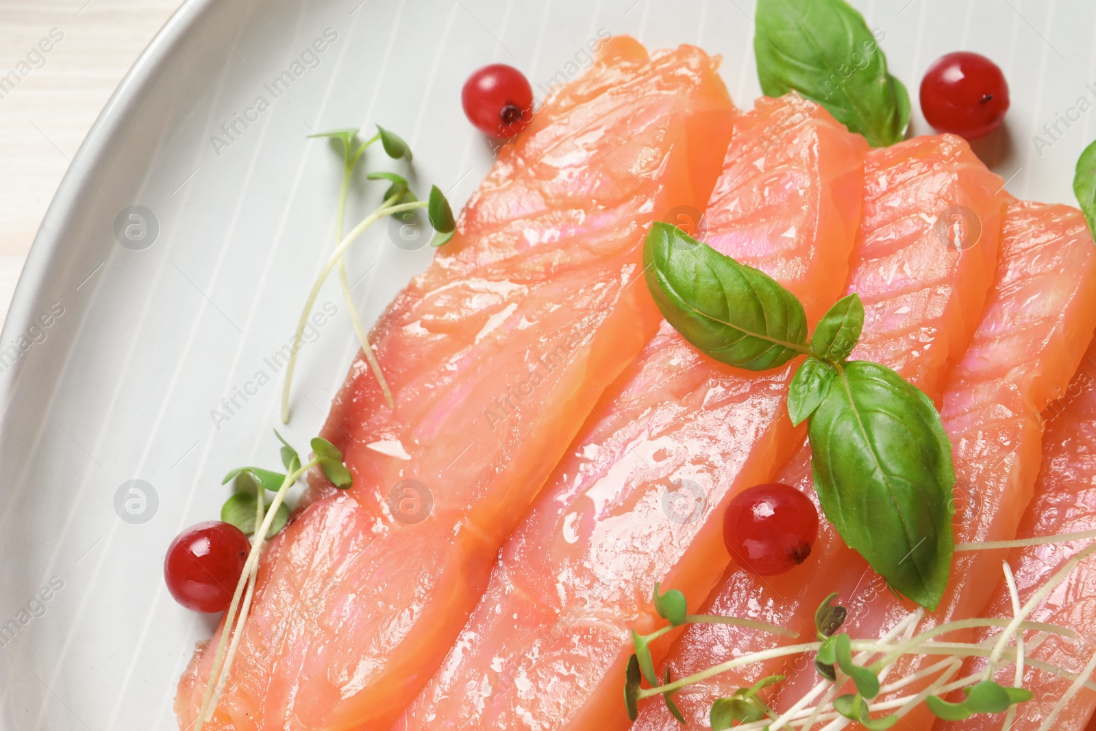Photo of Delicious salmon carpaccio served on white table, top view
