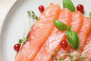 Photo of Delicious salmon carpaccio served on white table, top view