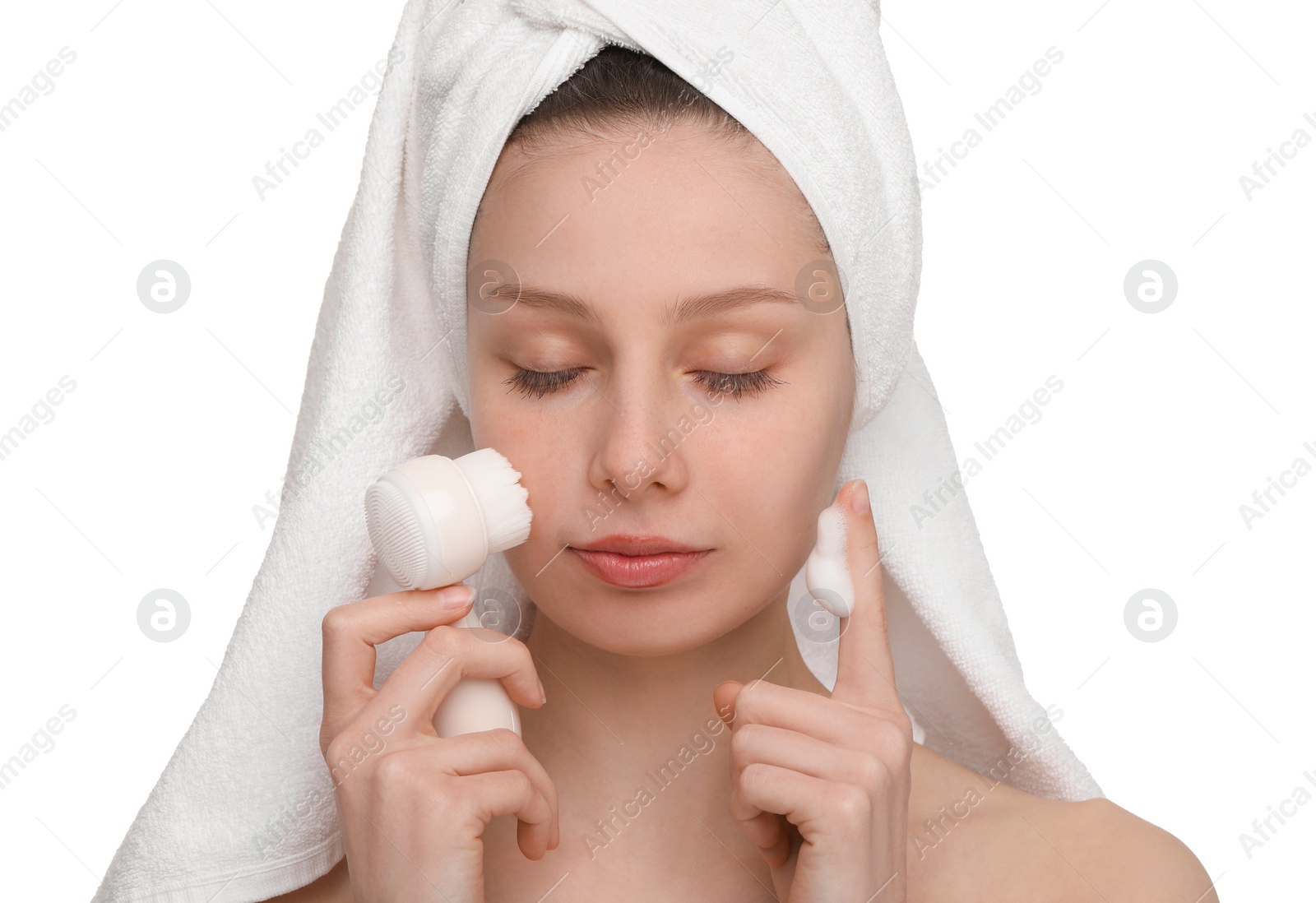 Photo of Washing face. Young woman with brush and cleansing foam on white background