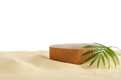 Photo of Presentation of product. Wooden podium and palm Leaf on sand against white background