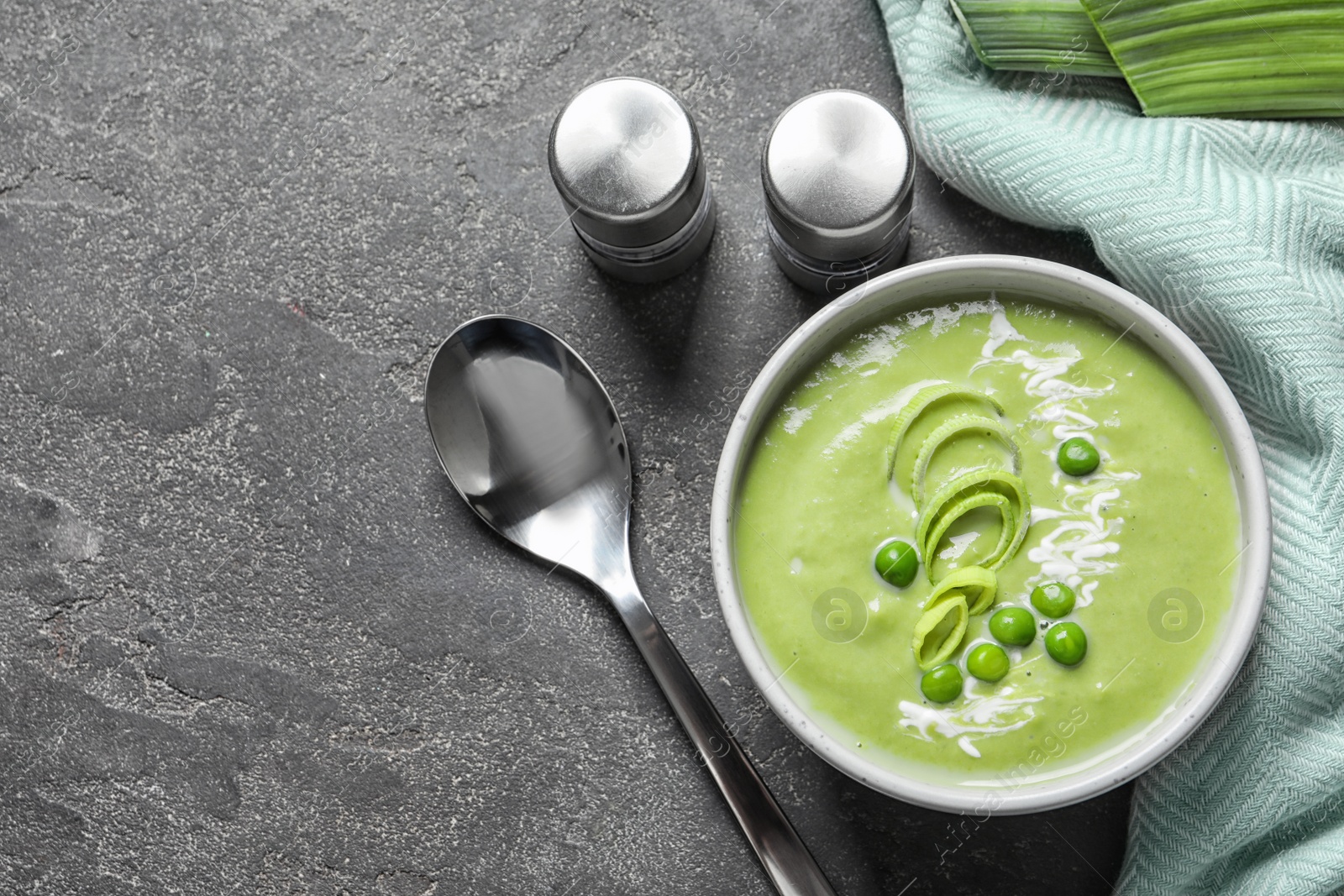 Photo of Fresh vegetable detox soup made of green peas served on table, top view. Space for text