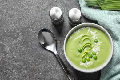 Fresh vegetable detox soup made of green peas served on table, top view. Space for text