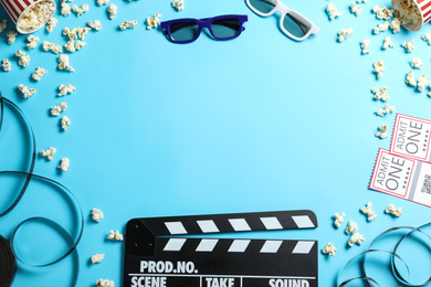 Photo of Flat lay composition with clapper board and cinema tickets on light blue background, space for text