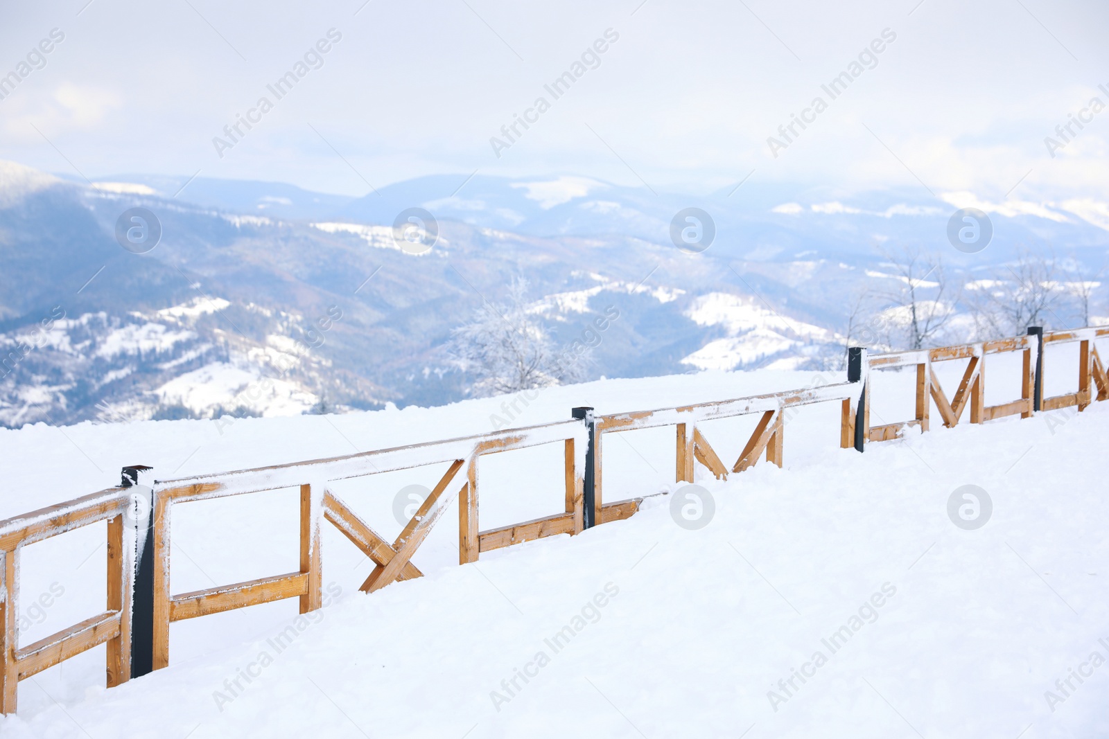 Photo of Picturesque view of snowy hills at mountain resort