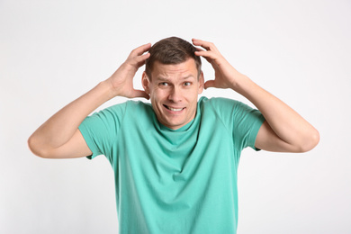 Photo of Emotional man in casual outfit on white background