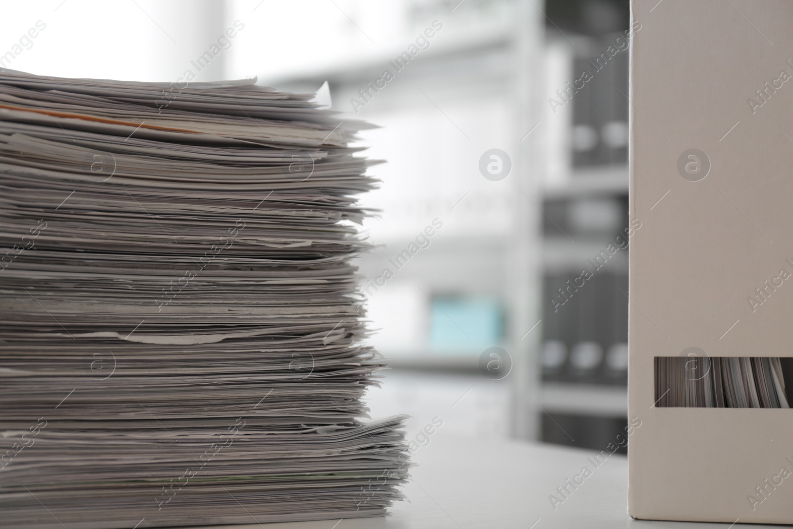 Photo of Stack of documents and folder with papers on table in office