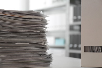 Photo of Stack of documents and folder with papers on table in office