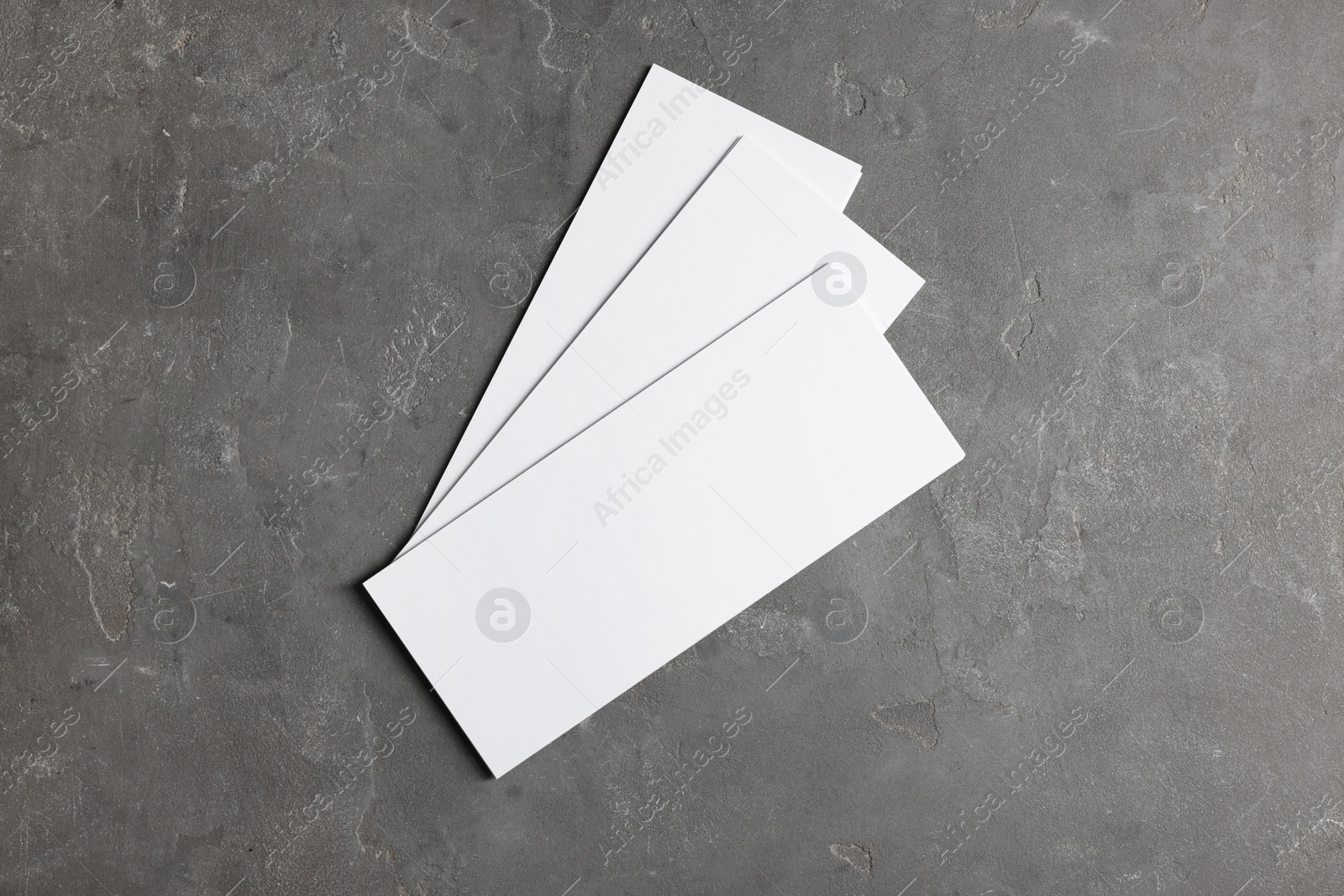 Photo of Blank business cards on grey textured background, top view. Mockup for design