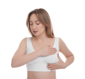 Photo of Mammology. Young woman doing breast self-examination on white background